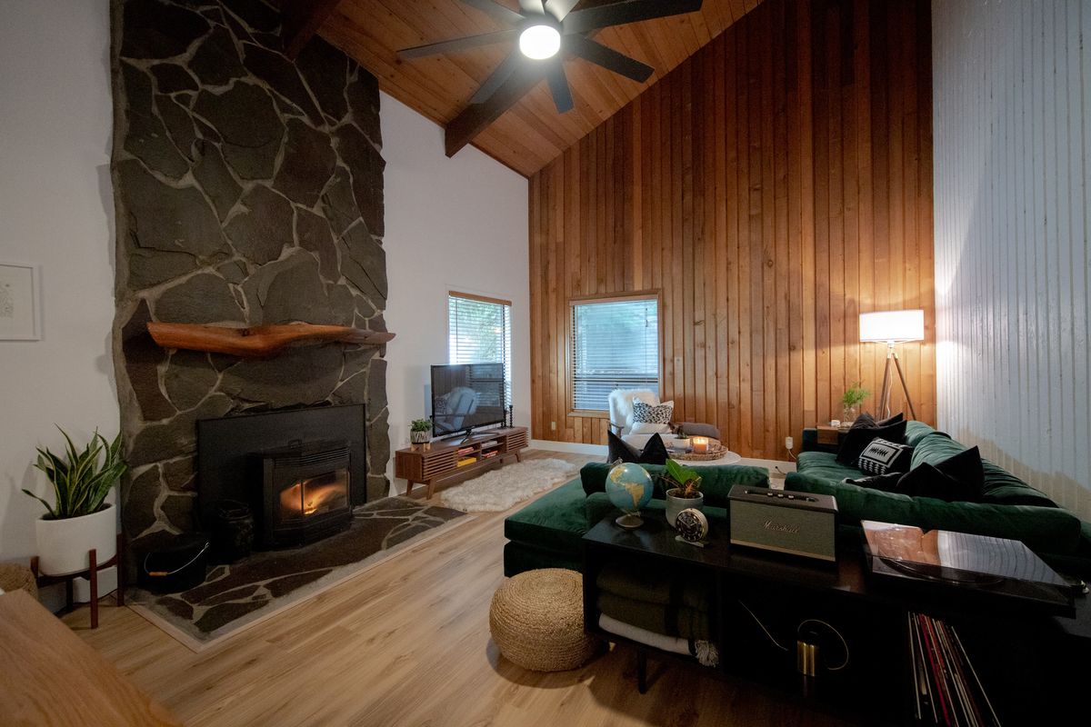 Stone fireplace and wood-paneled wall in the living room